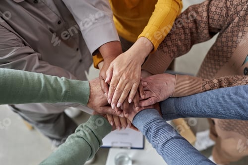 Preview: Top view up of senior people stacking hands in circle
