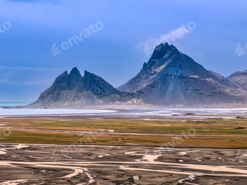 Preview: Vestrahorn mountain with blue sky and sand patterns.