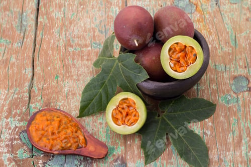 Preview: fruits of gulupa on vine wood table, Passiflora pinnatistipula