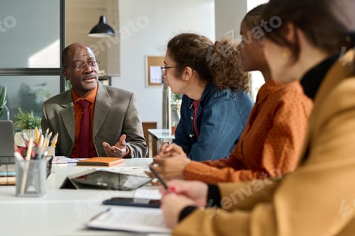 Preview: Diverse Group of Business People at Meeting Table