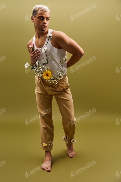 Preview: Young man embodies style and nature in vibrant floral-themed studio shoot