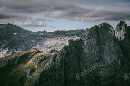 Preview: Landscape view of the rocky mountains against a clouded sky