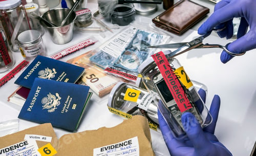 Preview: Scientific police opens with scissors a bag of evidence of a crime in scientific laboratory