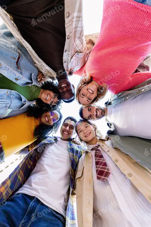 Preview: Happy young group of people smiling at camera standing in circle outside