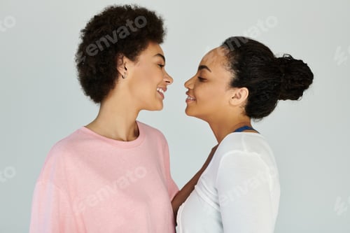Preview: Two friends sharing a joyful moment during an intimate conversation in a cozy indoor setting