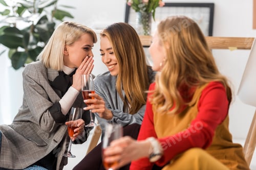 Preview: happy multiethnic magazine editors celebrating with champagne in modern office
