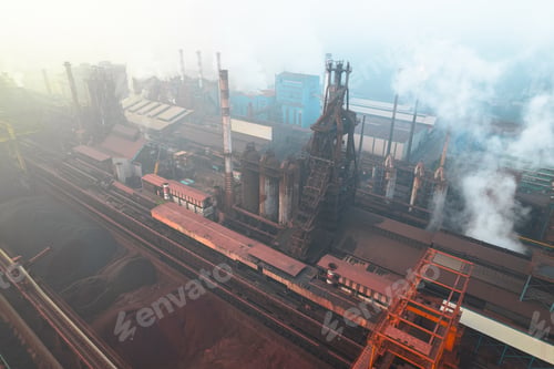 Preview: Industrial iron production factory during manifacture, aerial view from exterior,among smokes