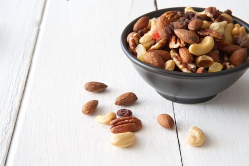 Preview: Mix nuts and dried fruits in the bowl put on the white painted wooden.