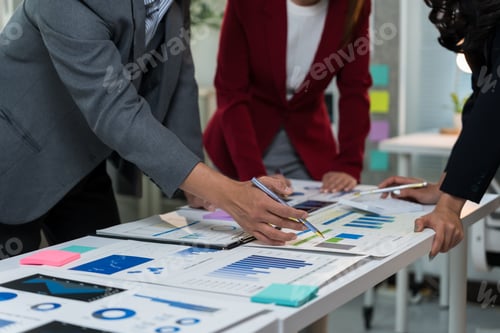 Preview: Business team analyzing marketing strategy with charts and graphs showing company performance