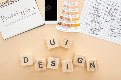 Preview: top view of smartphone near website design template, color palette and notebook with prototyping