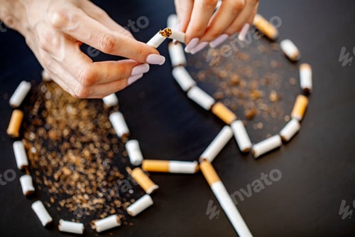 Preview: Stop smoking concept on background with broken cigarettes. Heap of cigarettes. No smoking