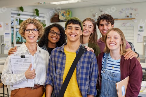 Preview: Group of happy smiling students with mature teacher at secondary school
