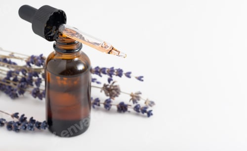 Preview: Essential oil with a dropper and lavender branches. Brown glass cosmetic bottle, serum