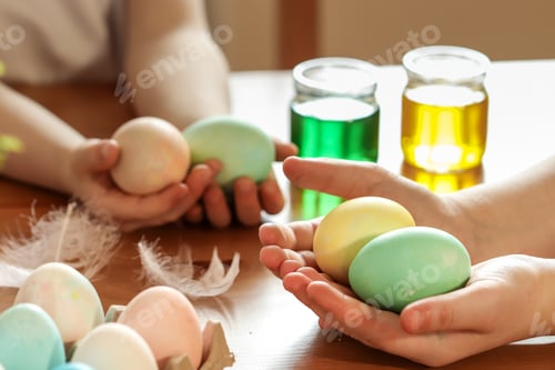 Preview: The girls help their mother in preparing for Easter. Easter eggs. Pastel shades. hands close up