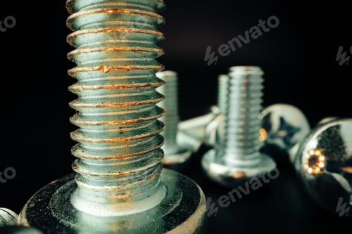 Preview: Metal screws and nuts on black background