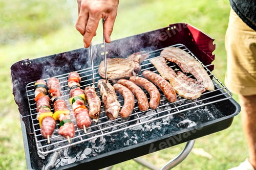 Preview: Hand closeup grilling meat at home bar-b-q session