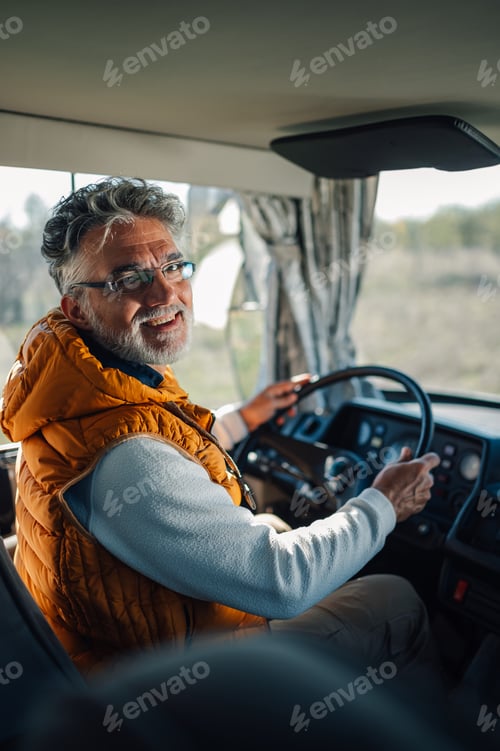 Preview: Senior bus driver smiling and driving public transportation vehicle