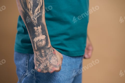 Preview: Cropped view of unrecognizable man hand with black tattoo