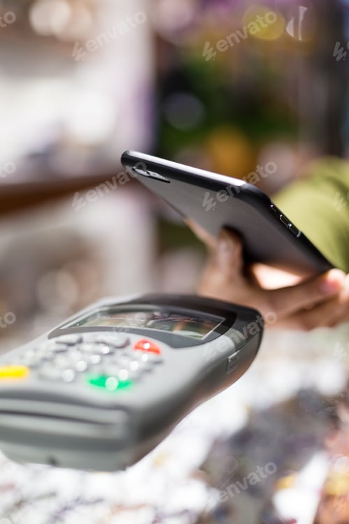Preview: Woman paying with NFC technology on celphone