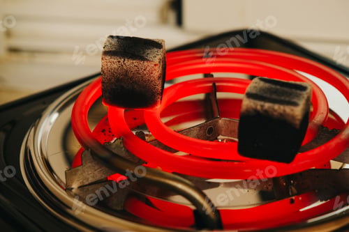 Aperçu: Coconut coals being heated for use in a hookah
