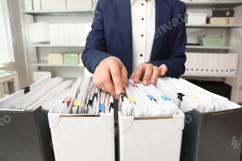 Preview: Woman taking documents from folder in archive, closeup