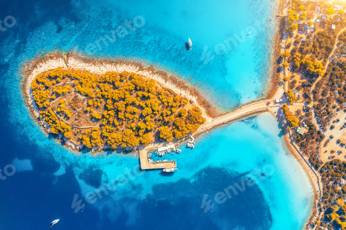 Preview: Aerial view of small island in sea bay at sunset in autumn