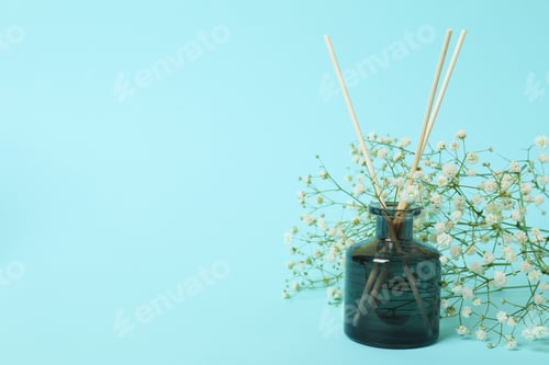 Preview: Aroma scent diffuser and flowers on blue background