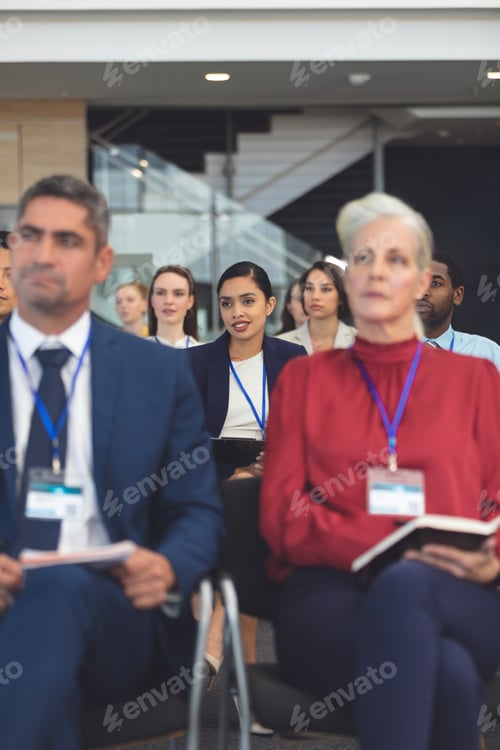 Preview: Front view of beautiful young mixed race businesswoman at a business seminar in office building
