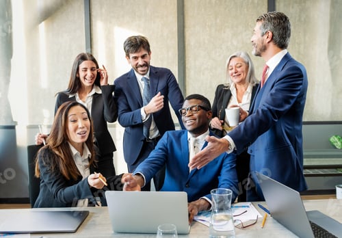 Preview: Group of multiethnic businesspeople discussing news near laptop