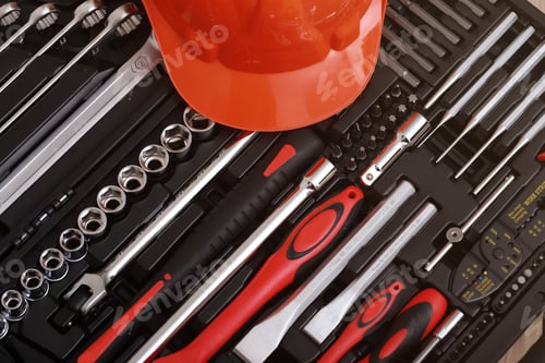 Preview: Toolbox, tools kit detail and orange protective helmet close up. instruments. set of tools