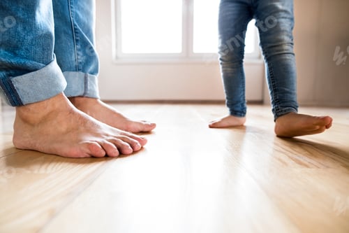 Preview: Beautiful young family. Bare feet of father and daughter.