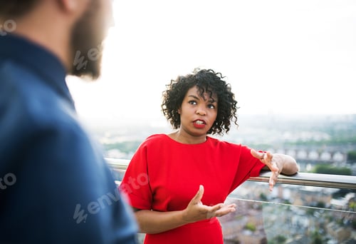 Preview: Two businesspeople standing against London view panorama.