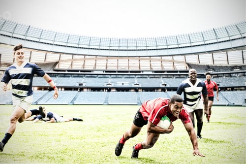 Preview: Digital composite image of rugby player jumping with the ball to score touchdown in sports stadium