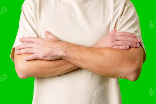 Preview: Person With Light Colored Shirt Crossing Arms Against Green Background