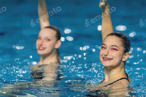Preview: Synchronized swimming duet dance. Synchronized swimming duet enchants the pool