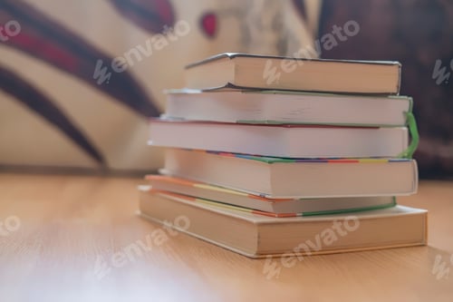 Preview: stack of books on wooden surface f