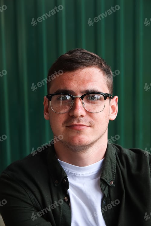 Preview: Portrait young man. Man wearing eyeglasses. Happy smiling smart man. Portrait of handsome smiling st