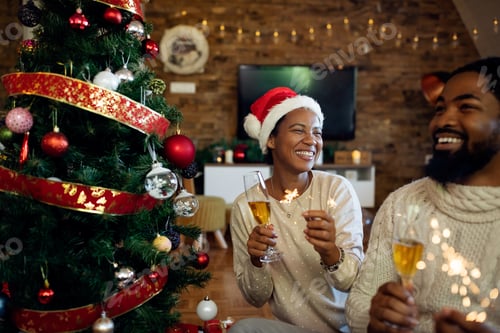 Preview: Joyful African American woman having fun with her husband on Christmas.