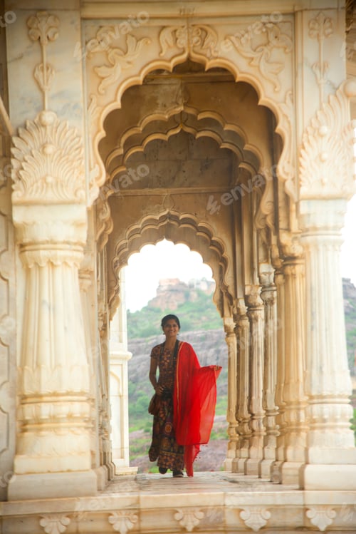Preview: Indian woman standing between arches and Pillars.