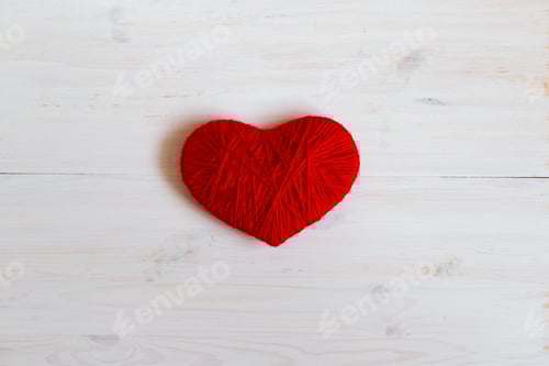 Preview: Red Yarn Heart on White Wooden Background