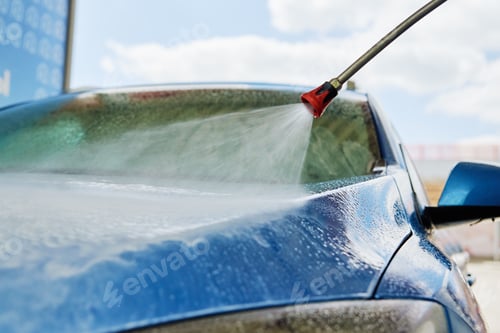 Preview: Cleaning car with high pressure water at car wash station