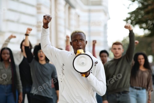 Preview: Black man with megaphone leading group of protestors