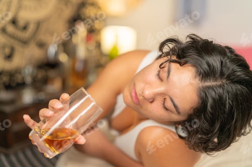 Preview: Drunk woman holding a glass and trying to drink