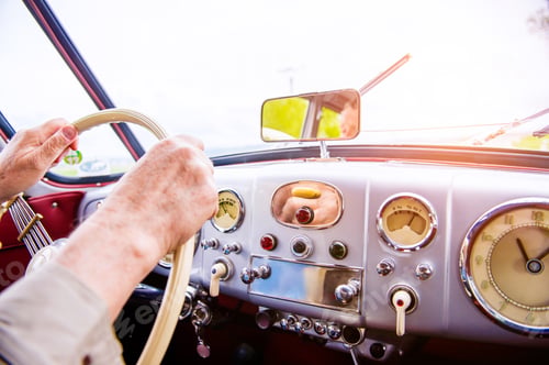 Preview: Close up unrecognizable man driving a veteran car