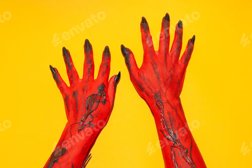 Preview: Creepy, red hands of a monster on a yellow background