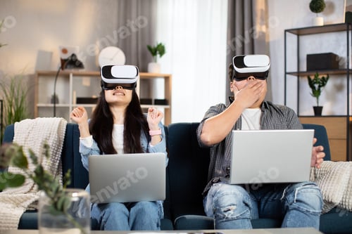 Preview: Excited chinese family using VR glasses for having fun at home