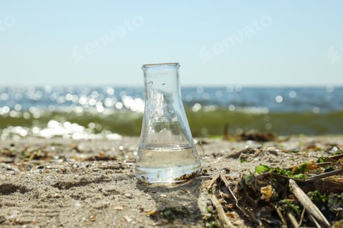 Preview: A test tube with contaminated water is standing on the bank of the river