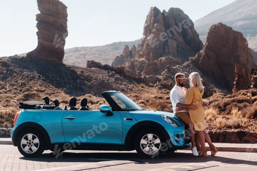 Preview: a woman and a man wearing glasses in a convertible car on a trip to the island of Tenerife. The