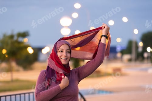 Preview: Smiling Arab woman in hijab on street