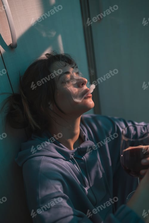 Preview: Female alcoholic smoking and drinking alone